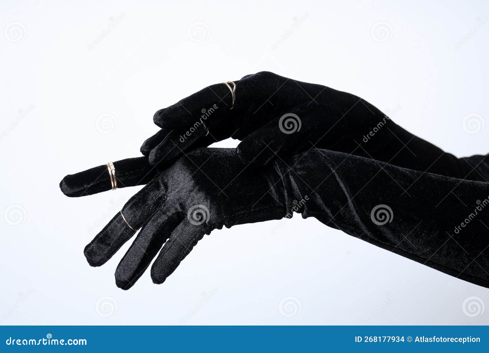Female Hands in Black Gloves with Rings on White Background Stock Photo