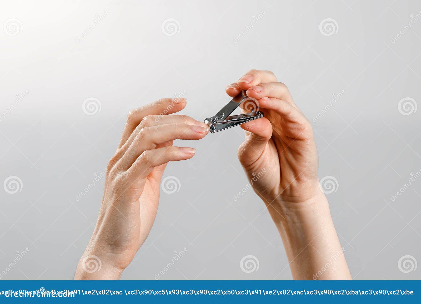 Female Hands Cut Off Nails on a White Background, Isolate Stock Photo