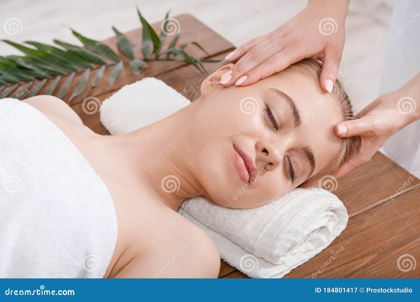 Female Hands Do Rejuvenating Face Massage For Woman On Table With Palm Leaf Stock Image Image