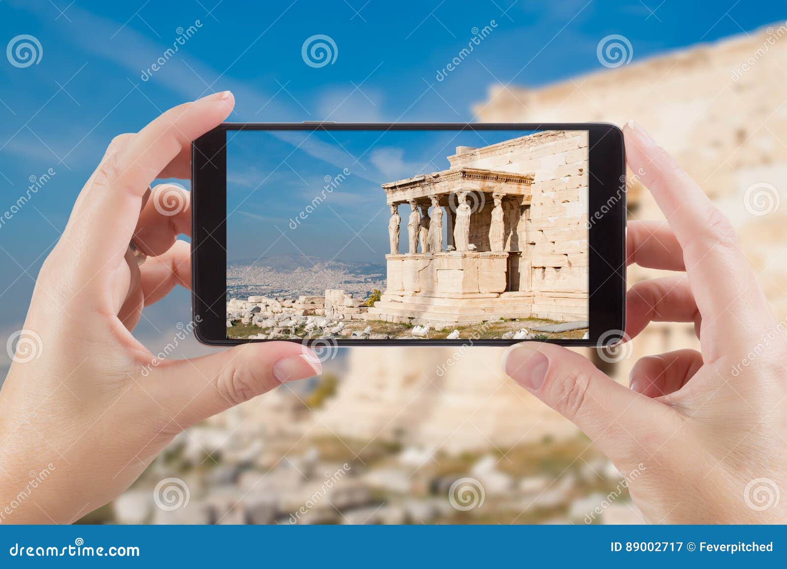 female hands holding smart phone displaying photo of caryatids i
