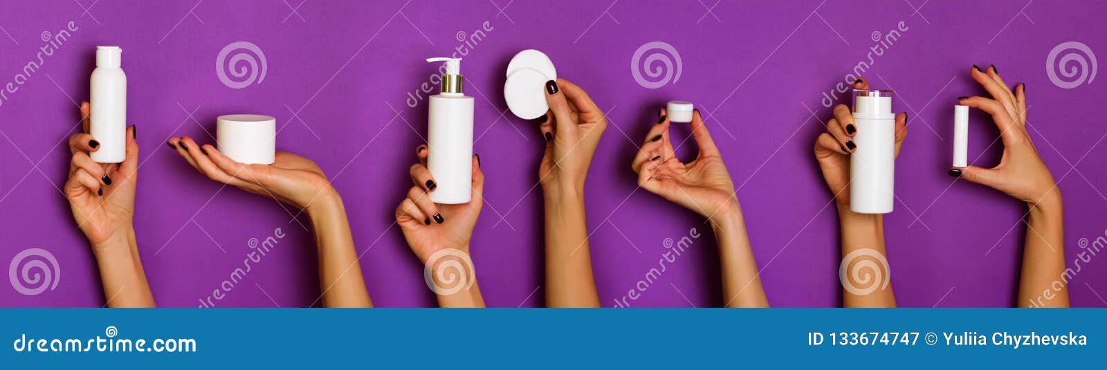 female hands holding white cosmetics bottles - lotion, cream, serum on violet background. banner. skin care, pure beauty, body