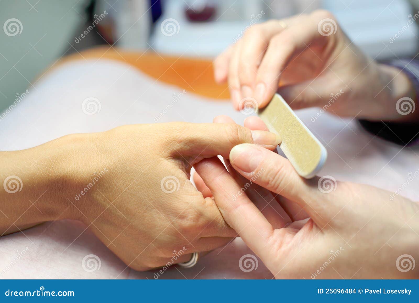 female hands make manicure by nailfile for woman