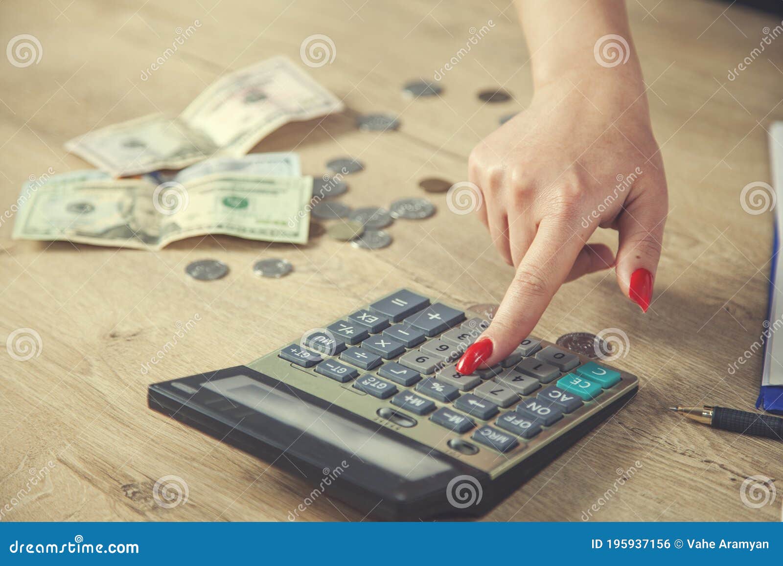 Female Hands with Red Nails on a Calculator Keyboard Stock Photo
