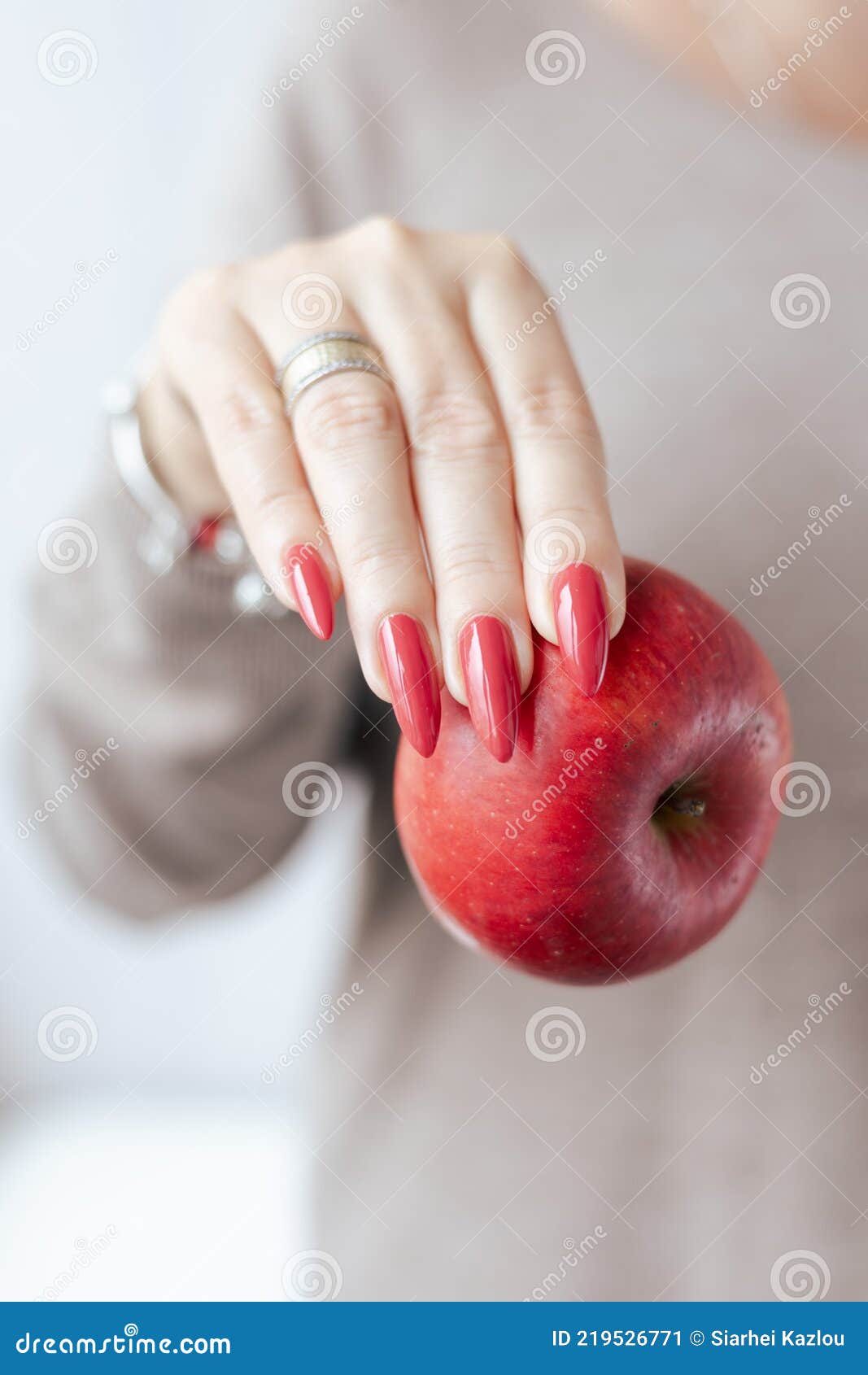 Female Hands with Red Nails are Holding a Ripe Red Apple Fruit. Stock ...