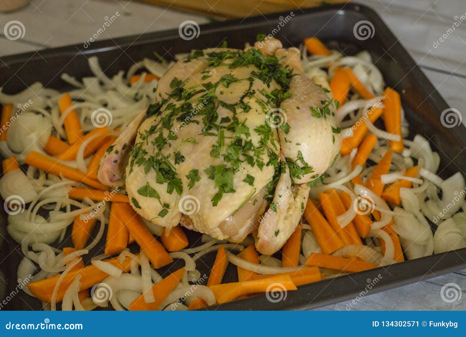 Female Hands Rubbing Pieces Of Parsley On Raw Chicken ...
