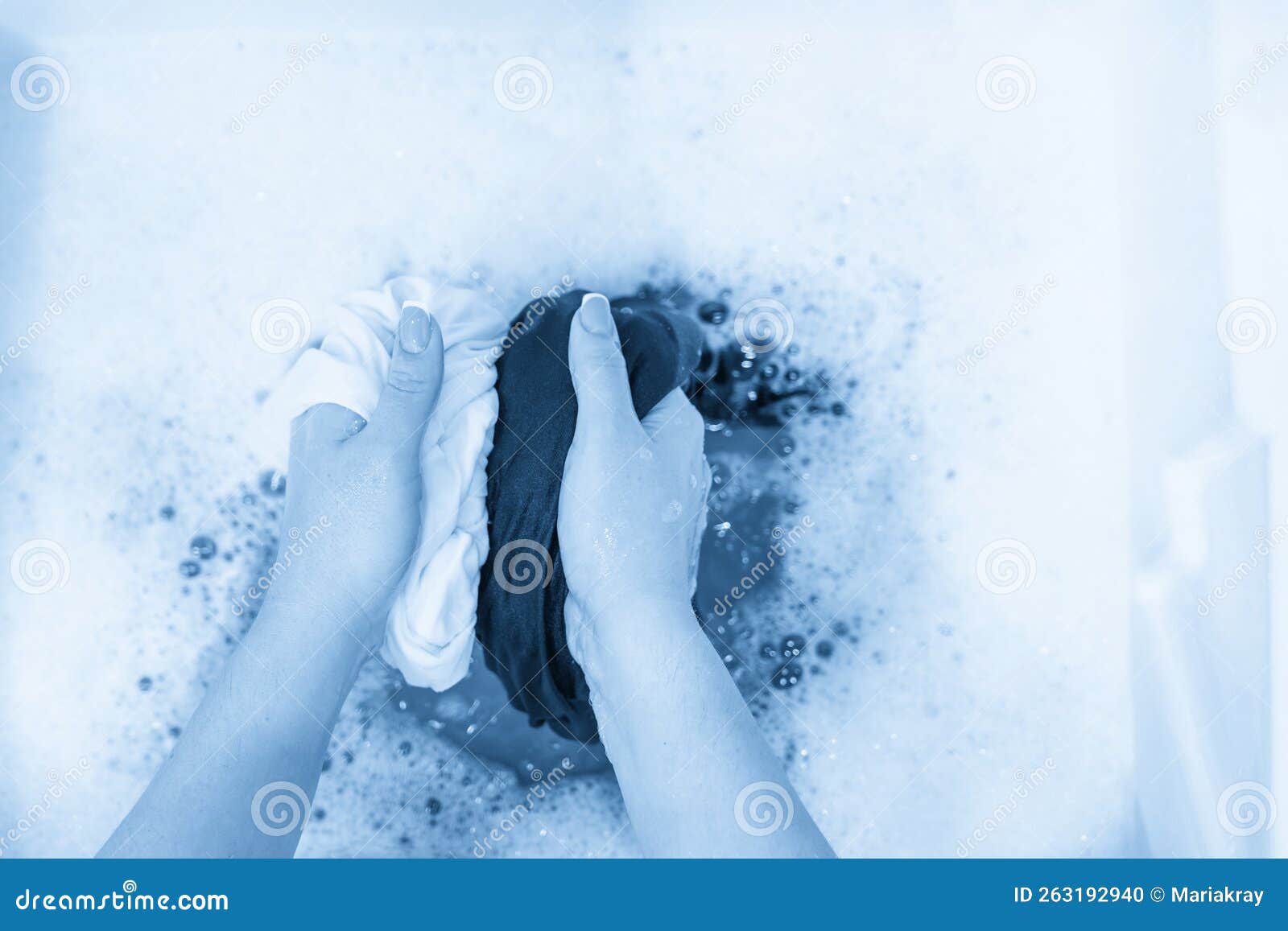 Female Hands Washing Black and White Clothes Together Stock Photo