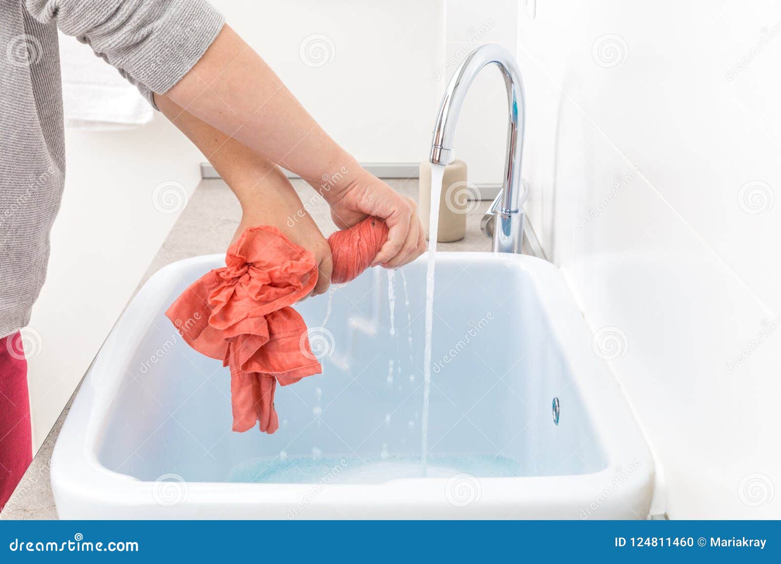 Female Hands Washing Color Clothes In Sink Stock Photo