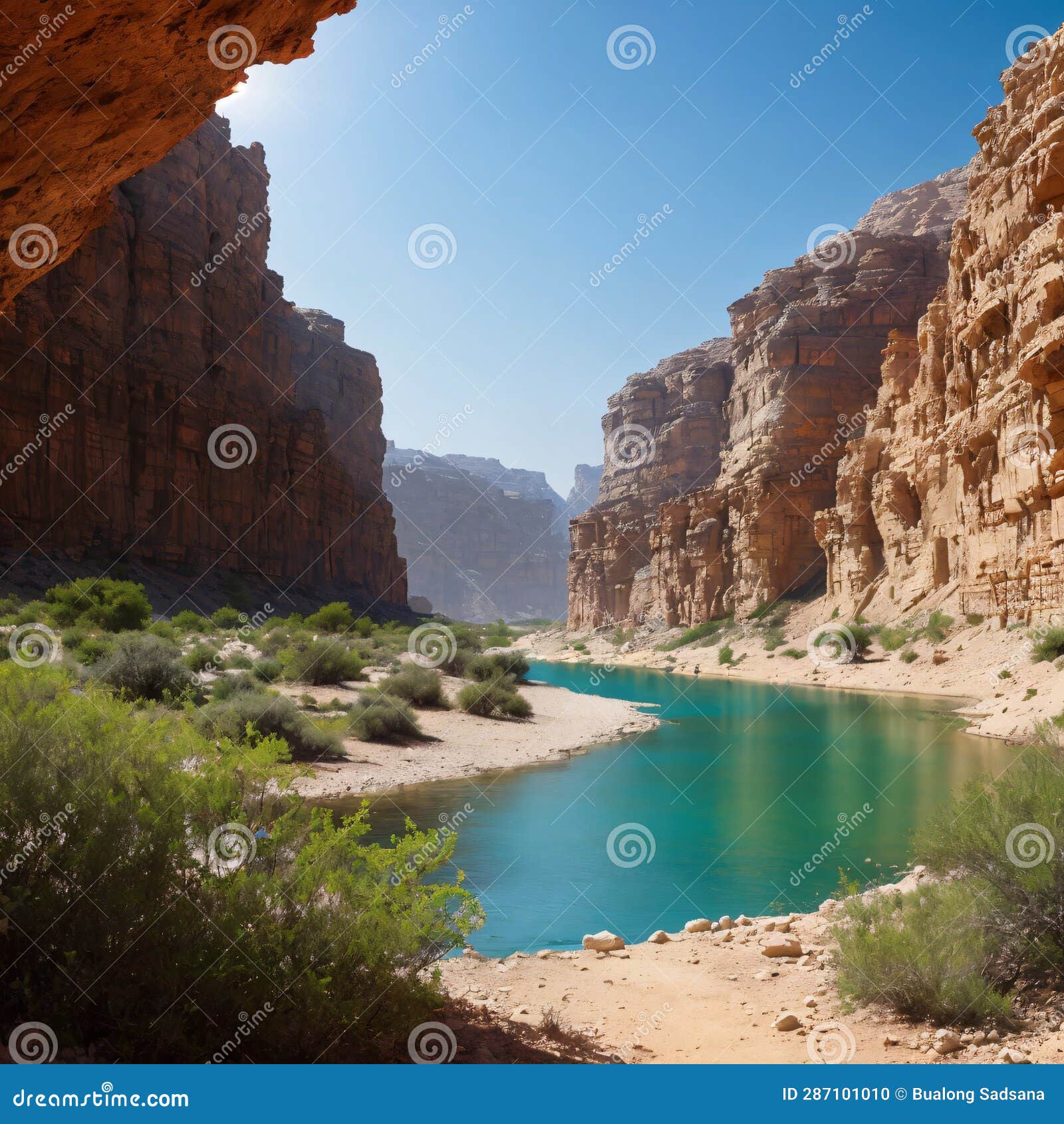 female hiker on a trail inside wadi taninim in a hot summer day, israel. green vegetation growing on the