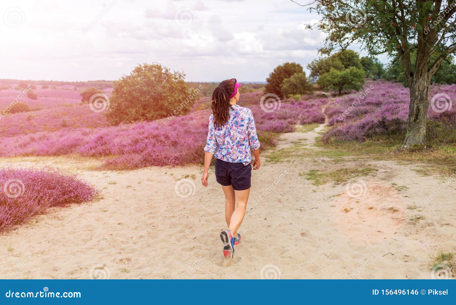 a female hiking along heather covered hills