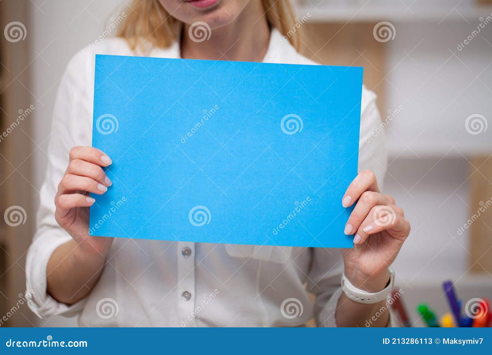 Female Holding a Blank Sheet of Paper with Space for Text Stock Image