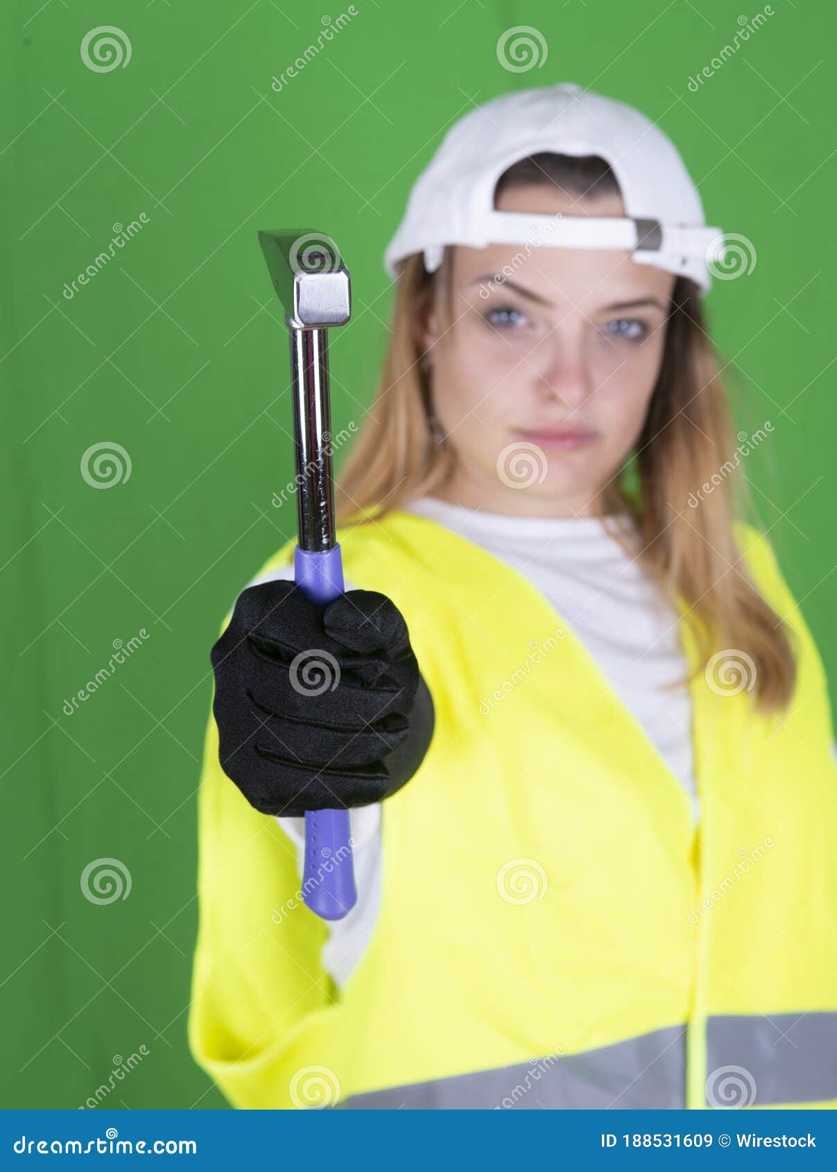 Female Holding a Hammer in a Reflective Security Vest Stock Image