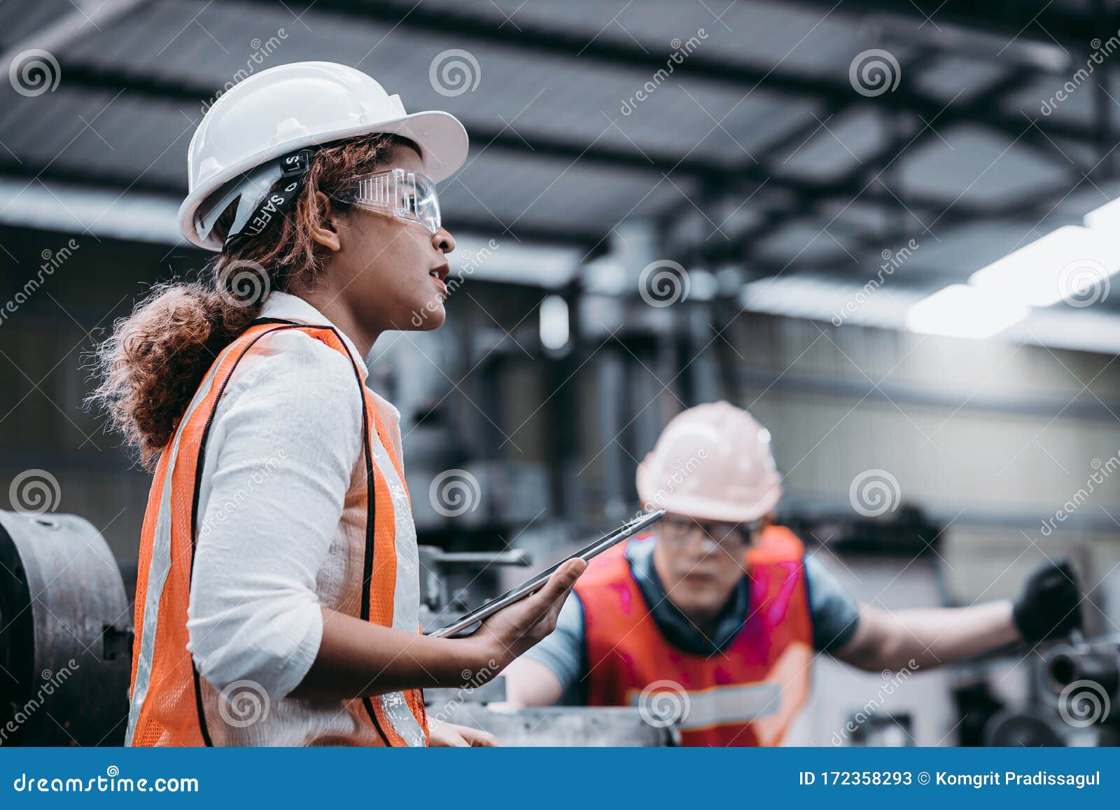 female industrial engineer wearing a white helmet while