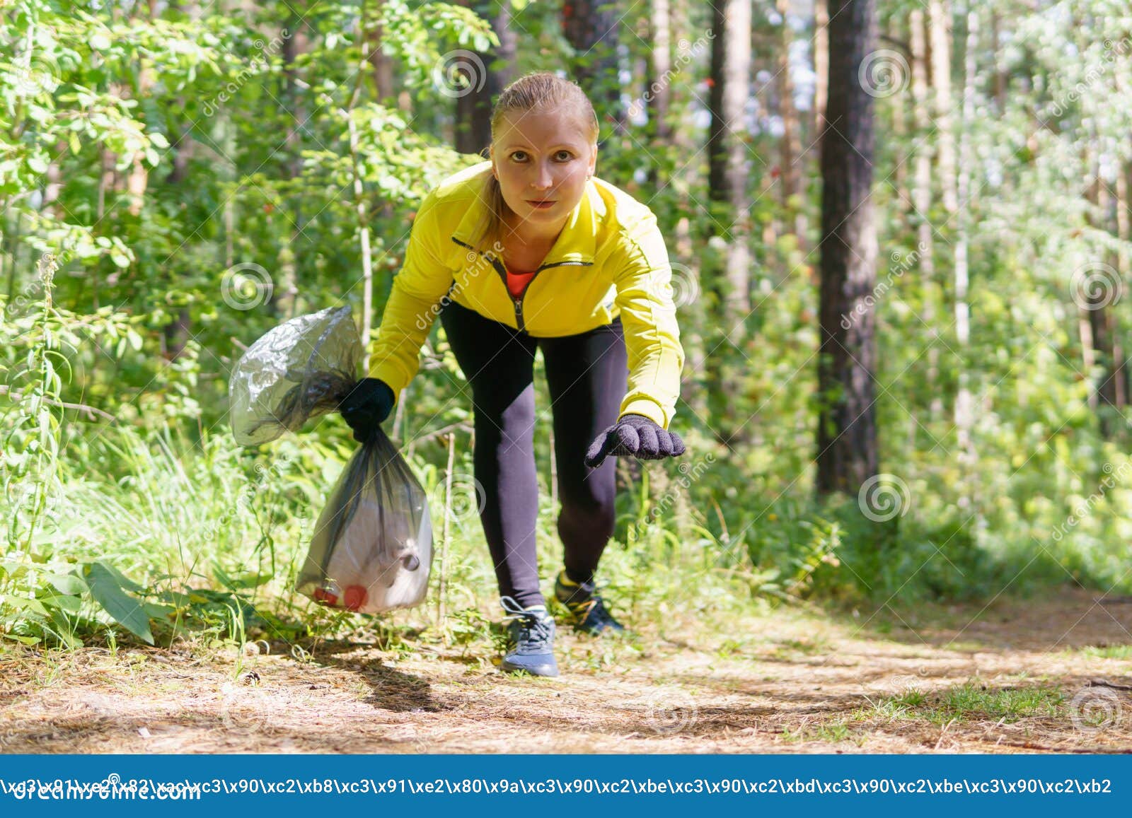 female jogger leans over trash during plogging