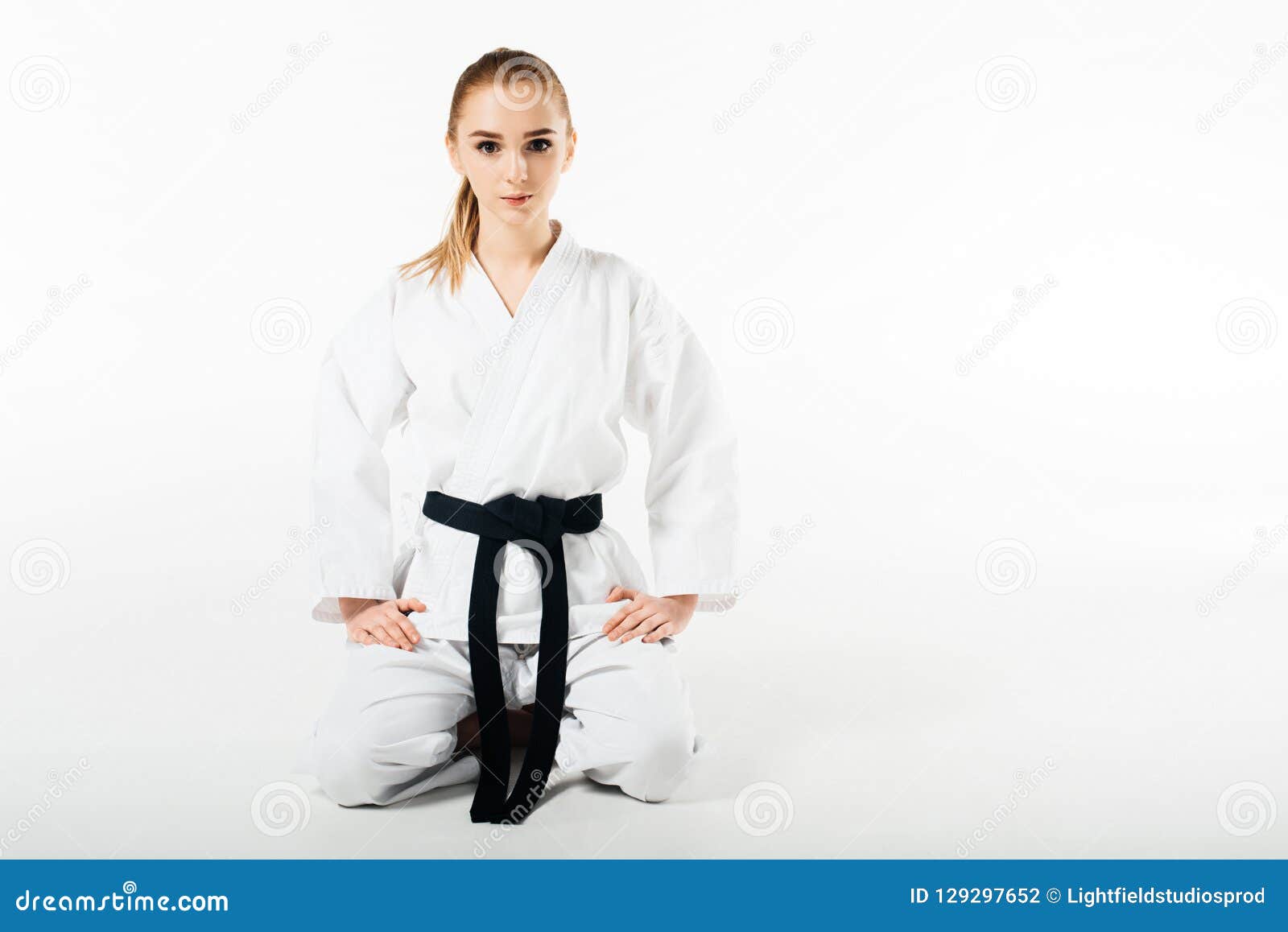 Female Karate Fighter Sitting and Looking at Camera Stock Photo Image