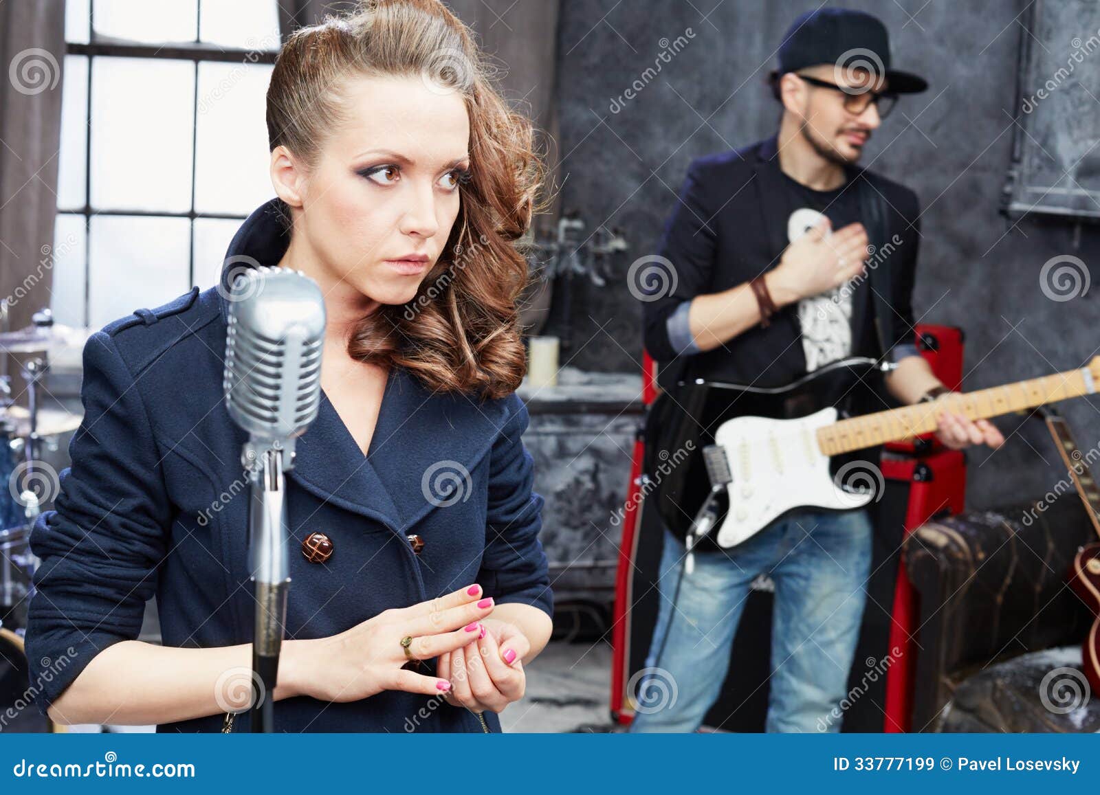 Female Lead Vocalist And Guitarist In Studio RoyaltyFree Stock Photo