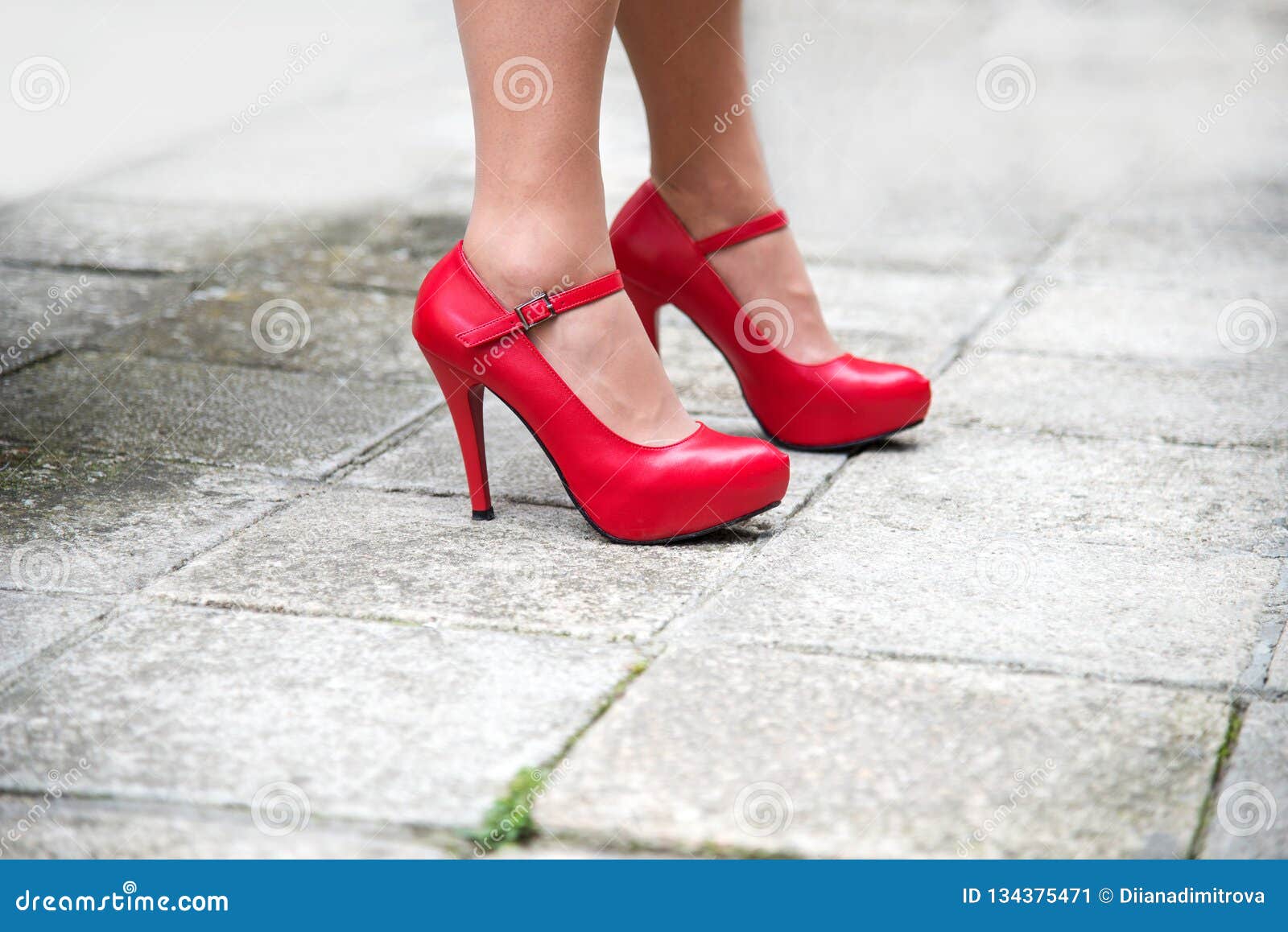 Female Legs in Bright Red Shoes with High Heels Against the Pavement ...