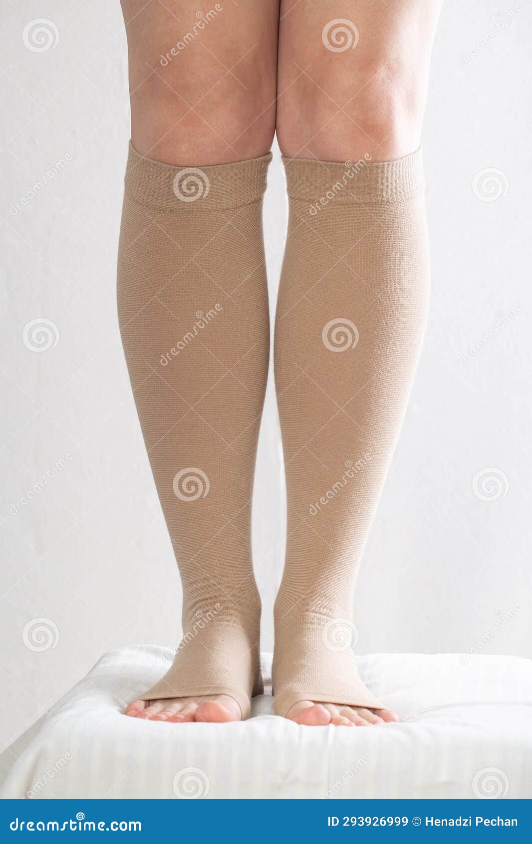 Female Legs in Compression Stockings for Varicose Veins on the