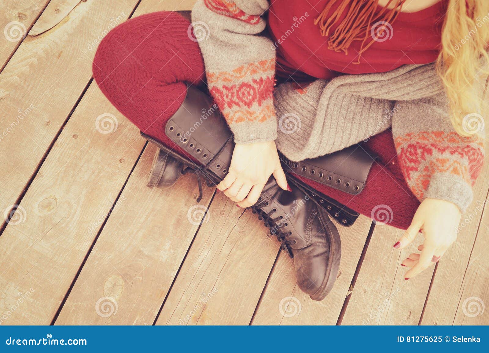 female legs dressed in leather shoes with laces and knitted stockings