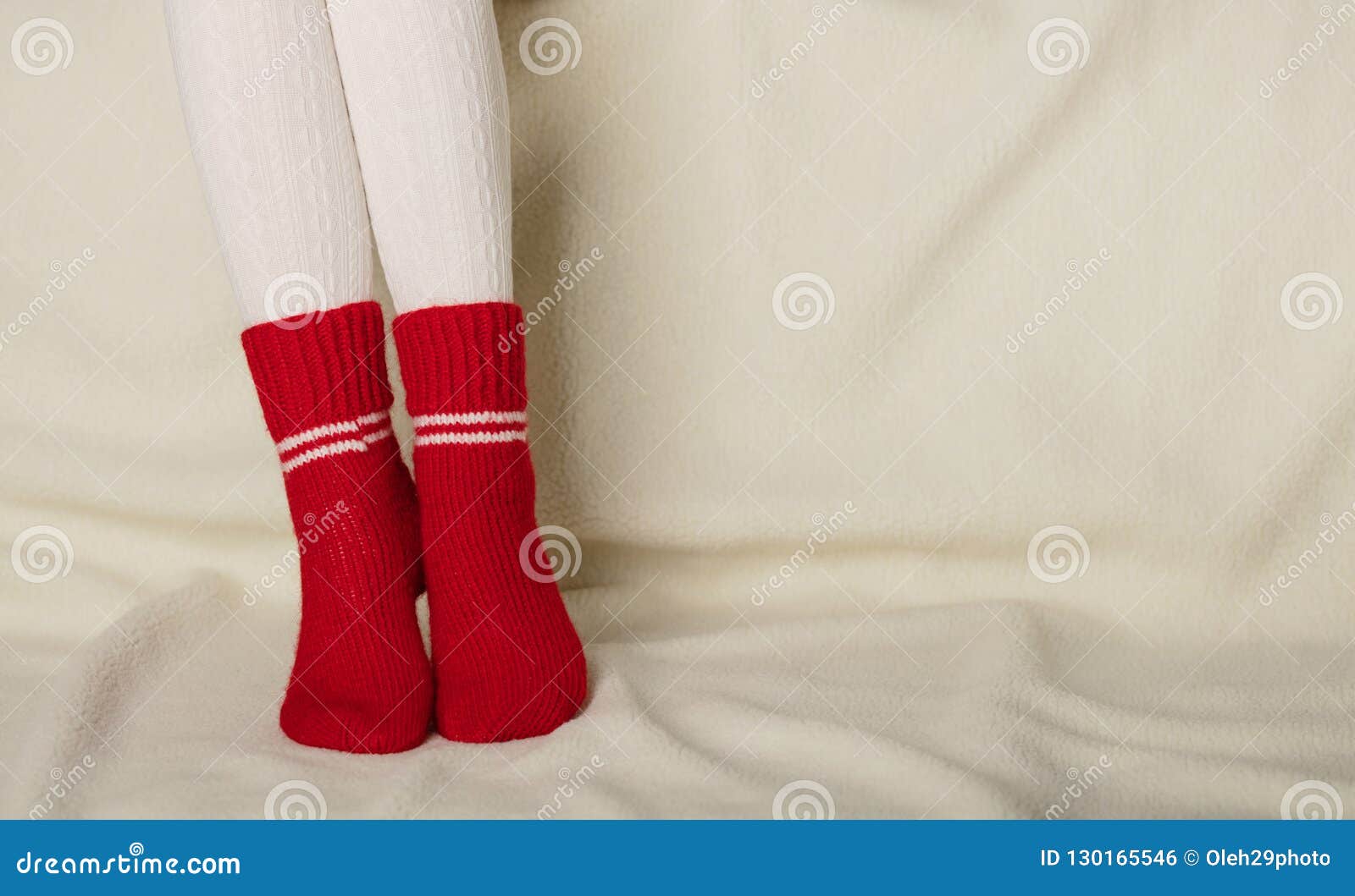 Female Legs in Warm White Knitted Tights and Red Socks on a Whit Stock ...