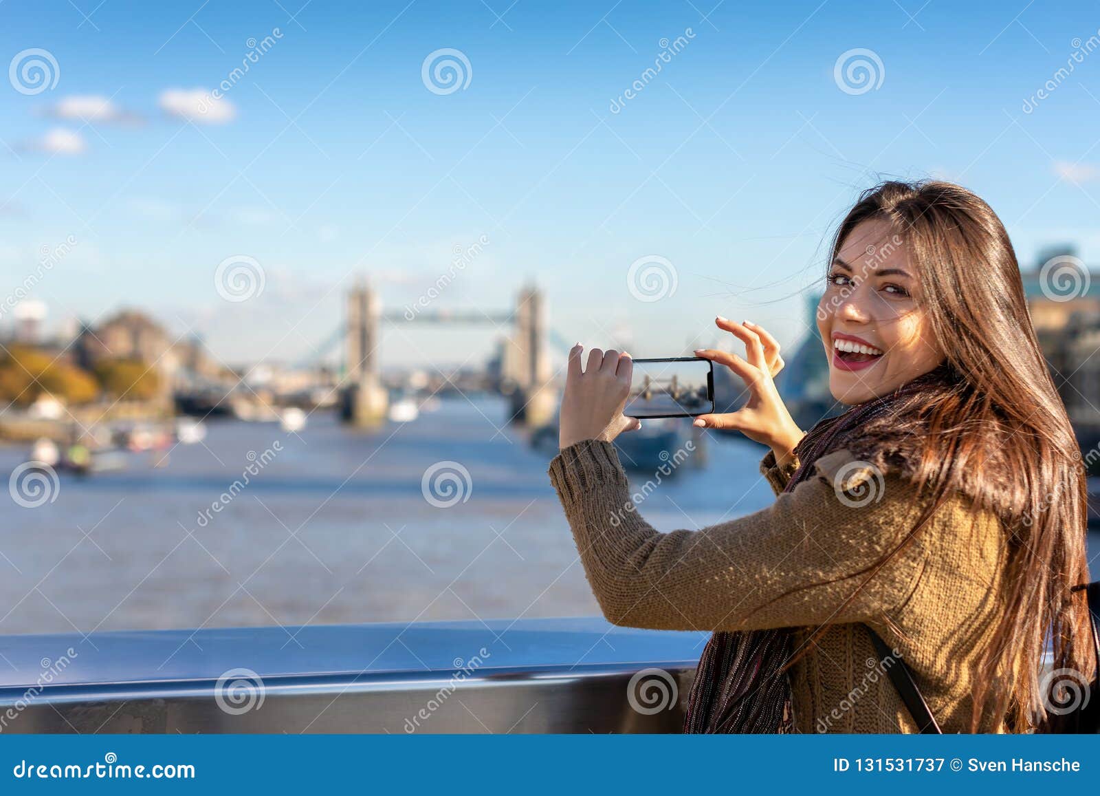 female london tourist is taking pictures of the tower bridge