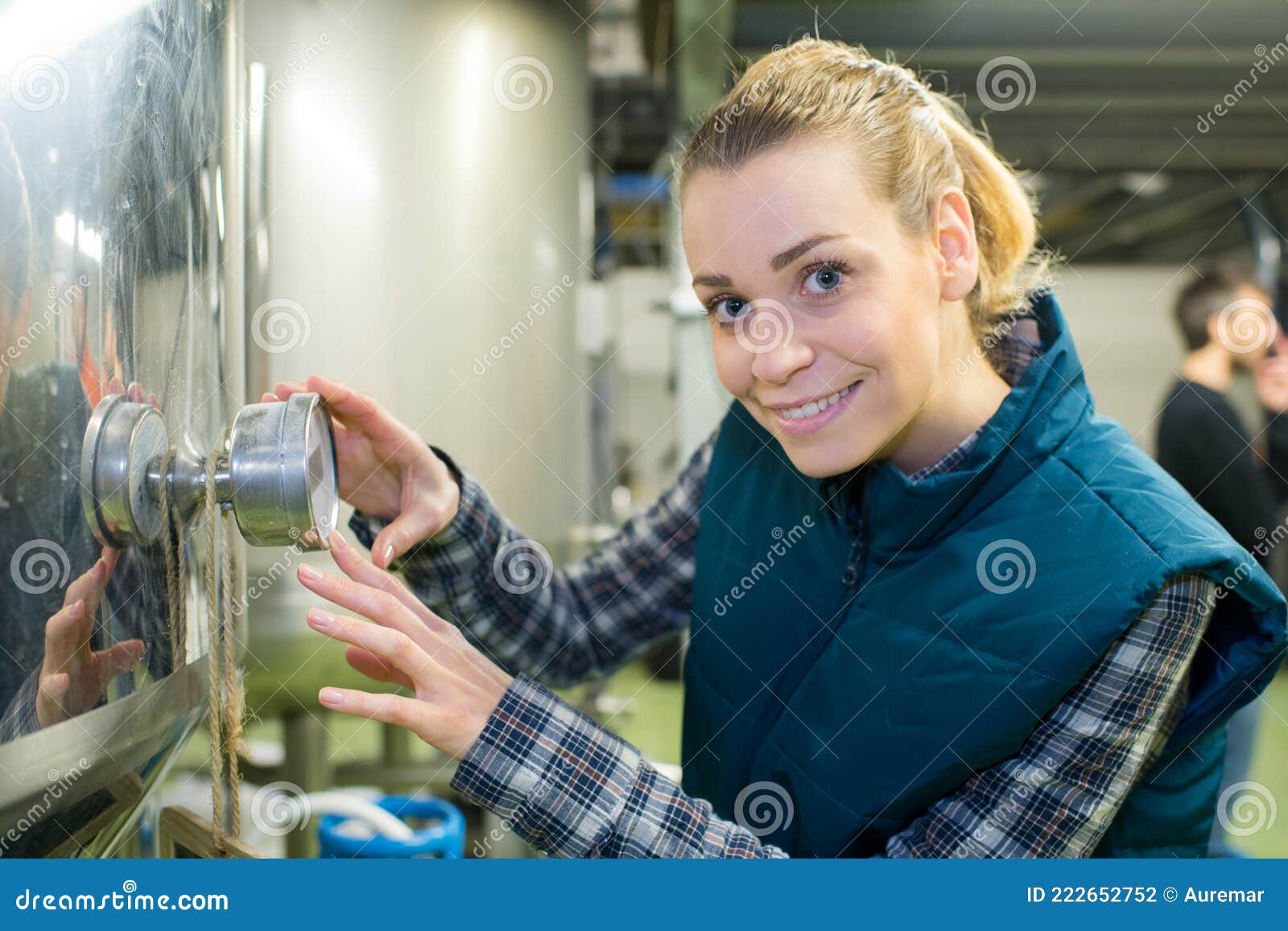 Female Maintenance Worker Examining Brewery Machine at Brewery Stock