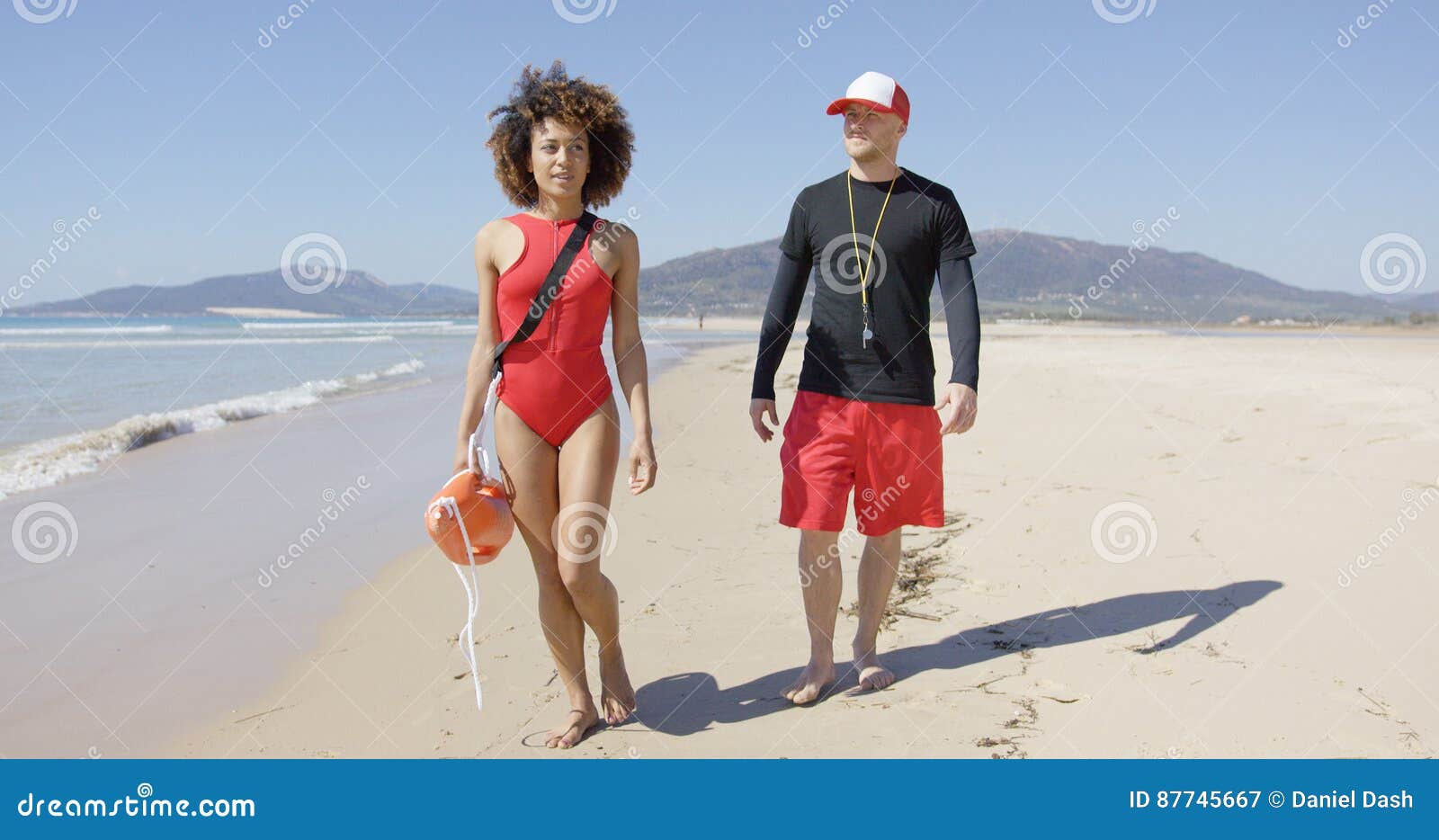 Female And Male Lifeguards Walking Along Beach Stock Image Image Of Shoreline Coast 87745667 