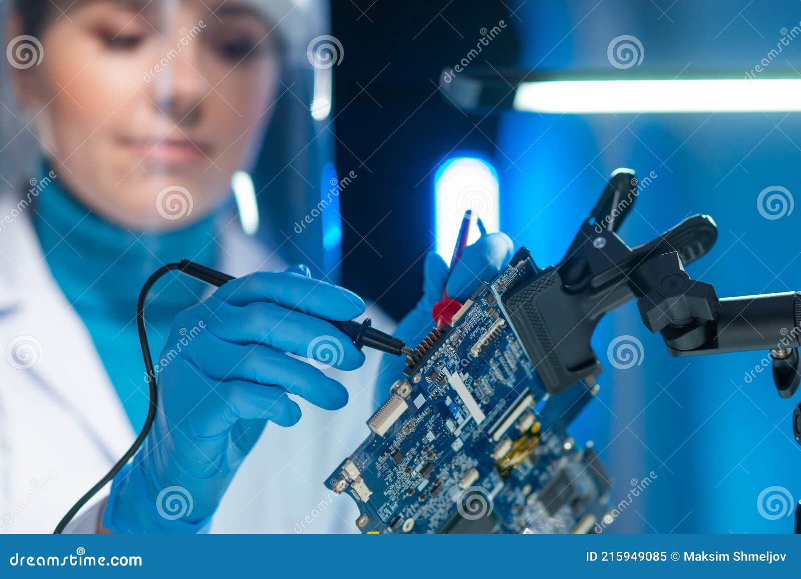 female microelectronics engineer works in a scientific laboratory on computing systems and microprocessors. professional