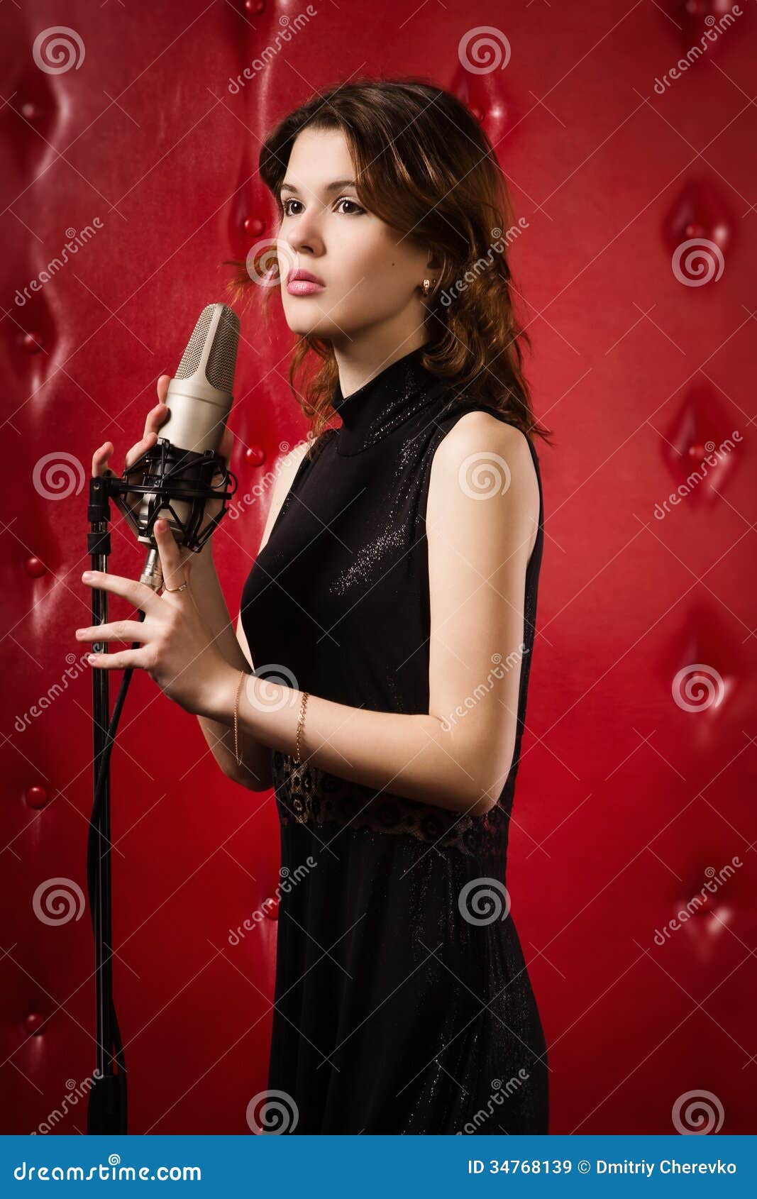Female With A Microphone On Stage Singing A Song Royalty Free Stock