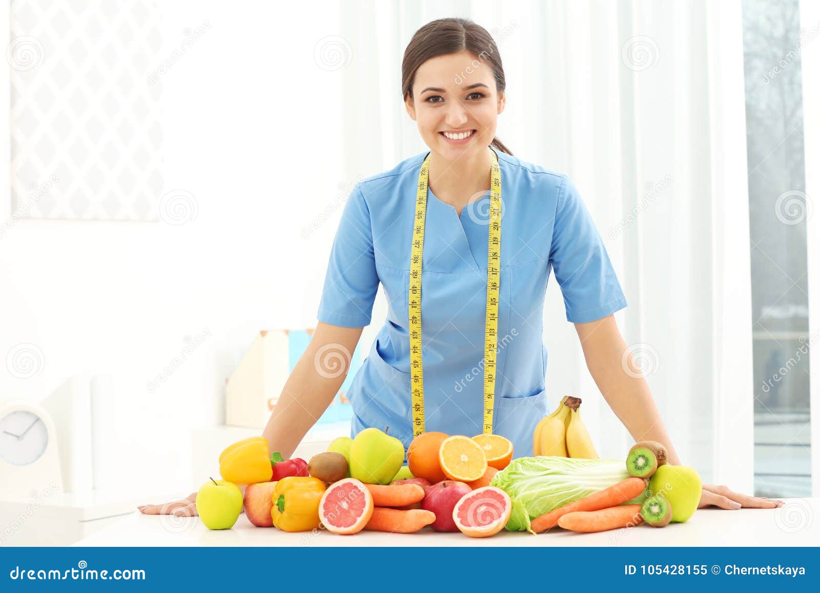 Female Nutritionist With Different Fruits And Vegetables Stock Image