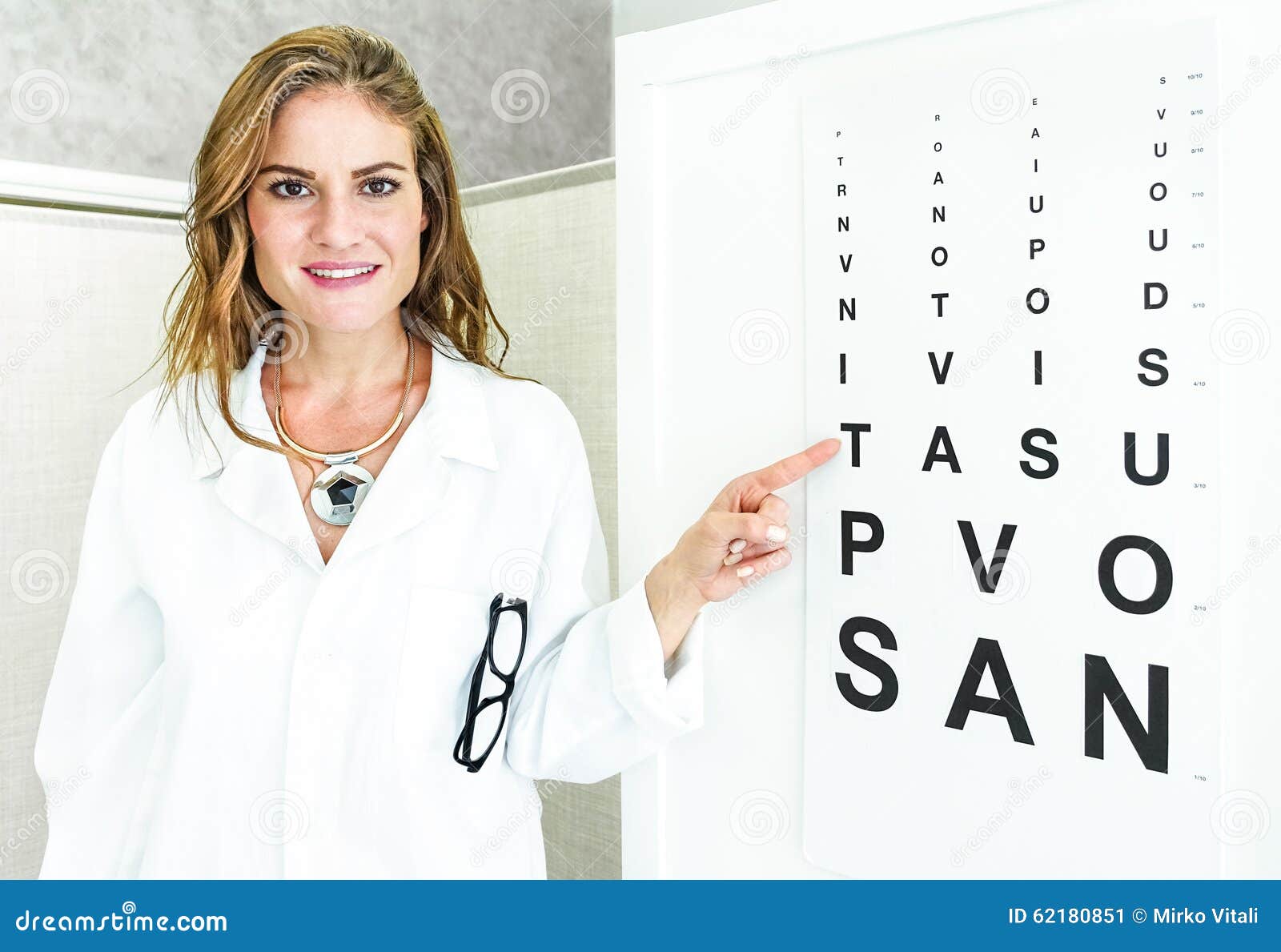 female oculist doctor pointing at eye sight test chart