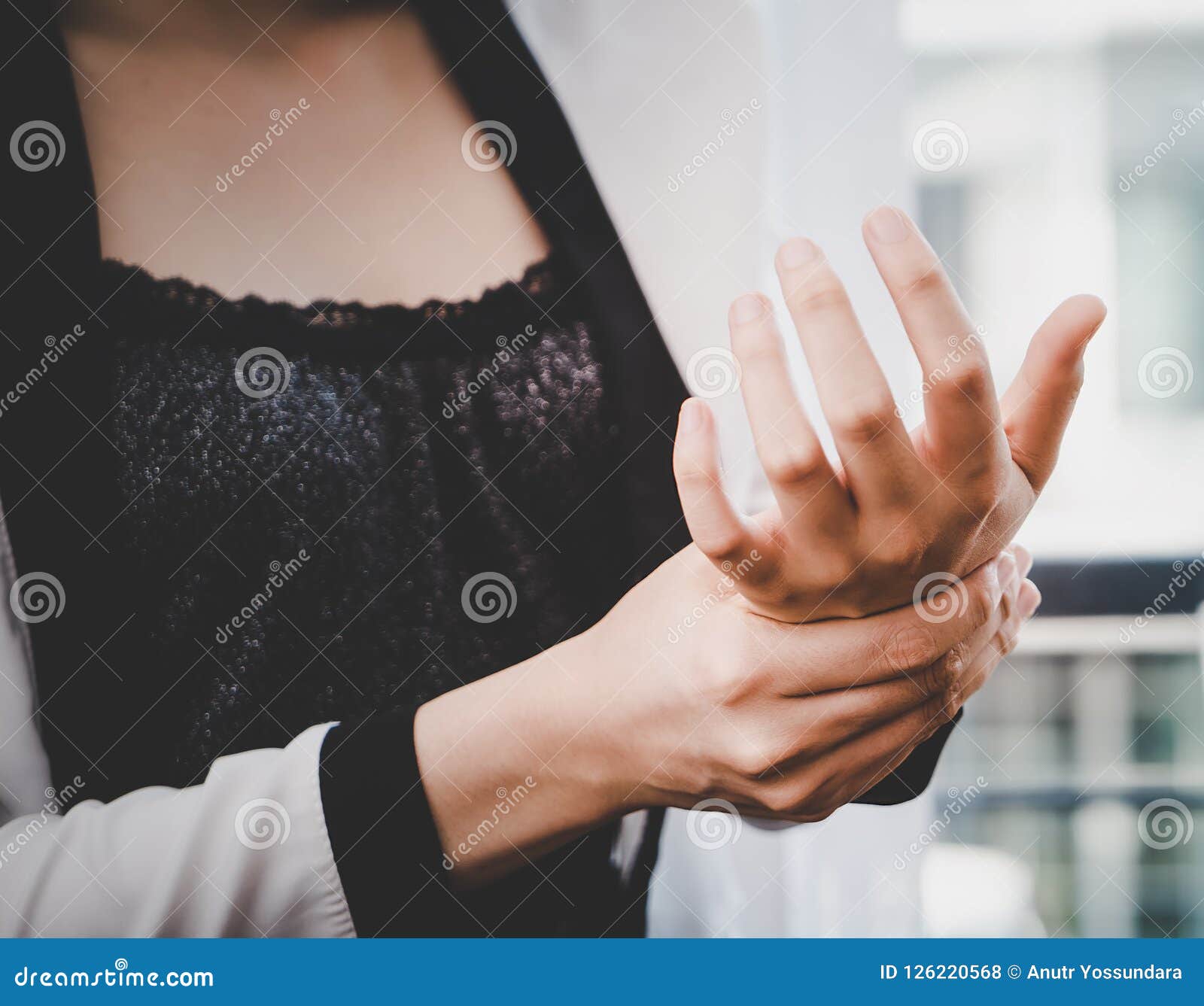 Female office worker is having office syndrome injury on her wrist