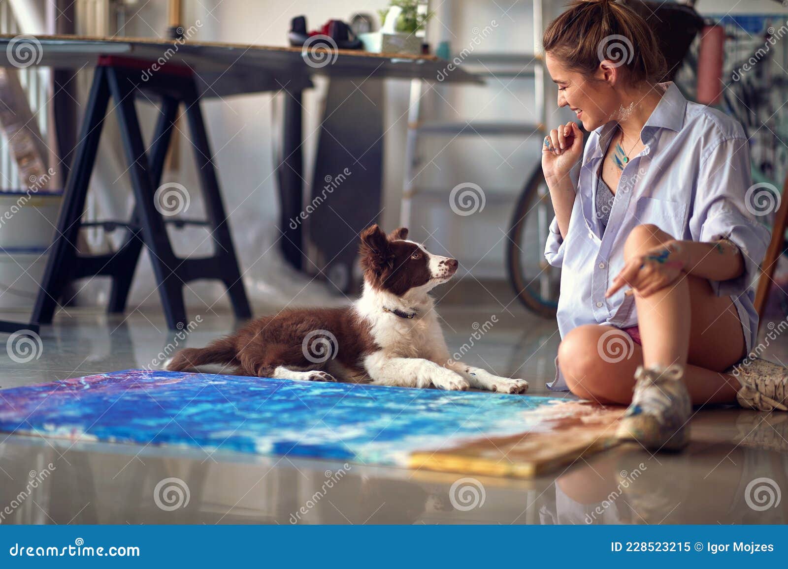 Female Painter in Art Studio Playing with Her Dog Stock Image Image