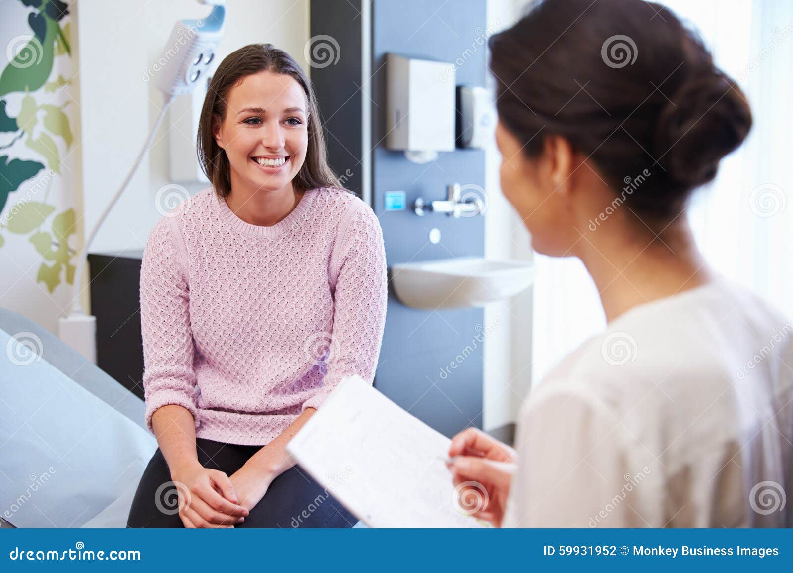 female patient and doctor have consultation in hospital room