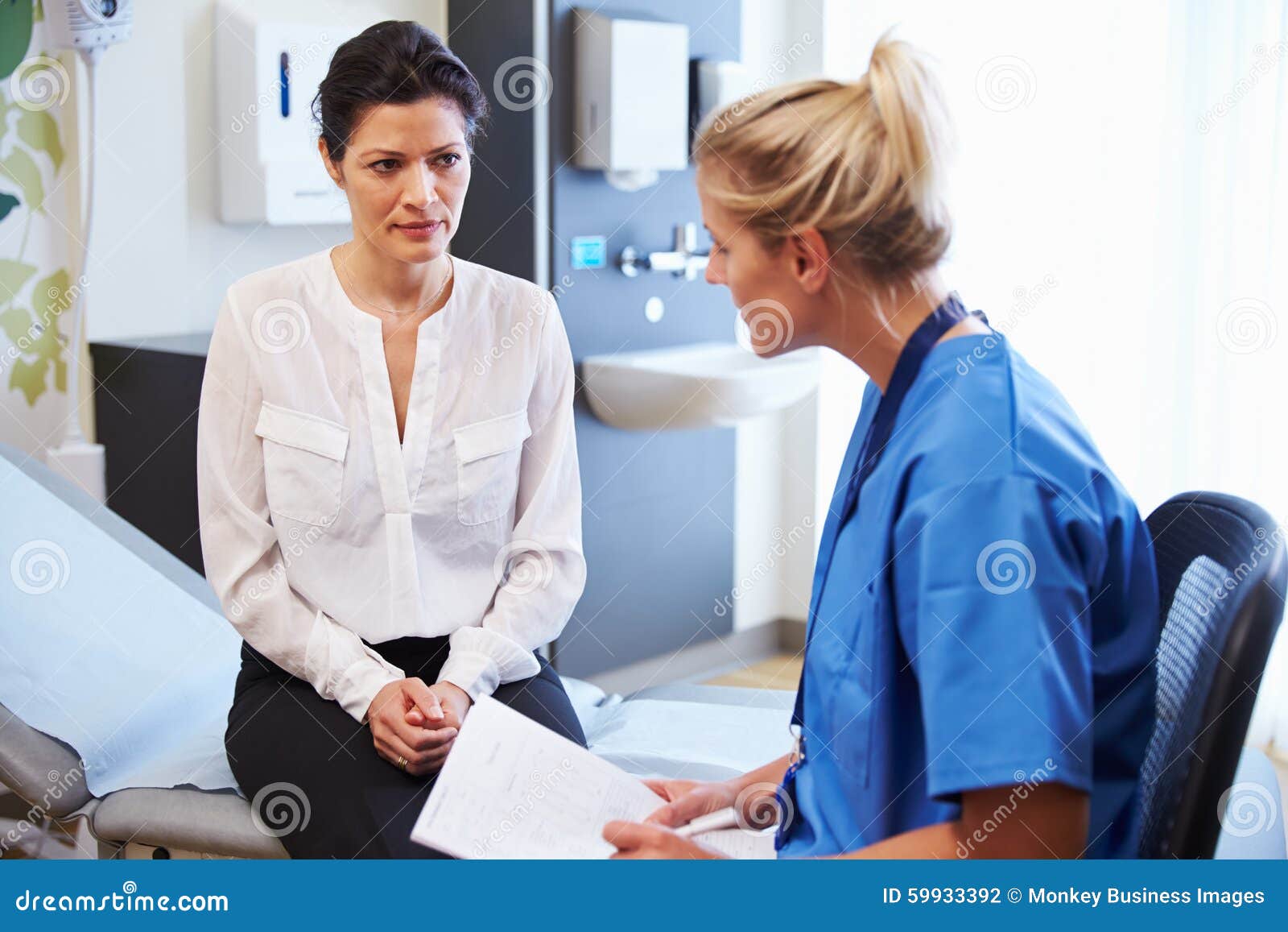 female patient and doctor have consultation in hospital room