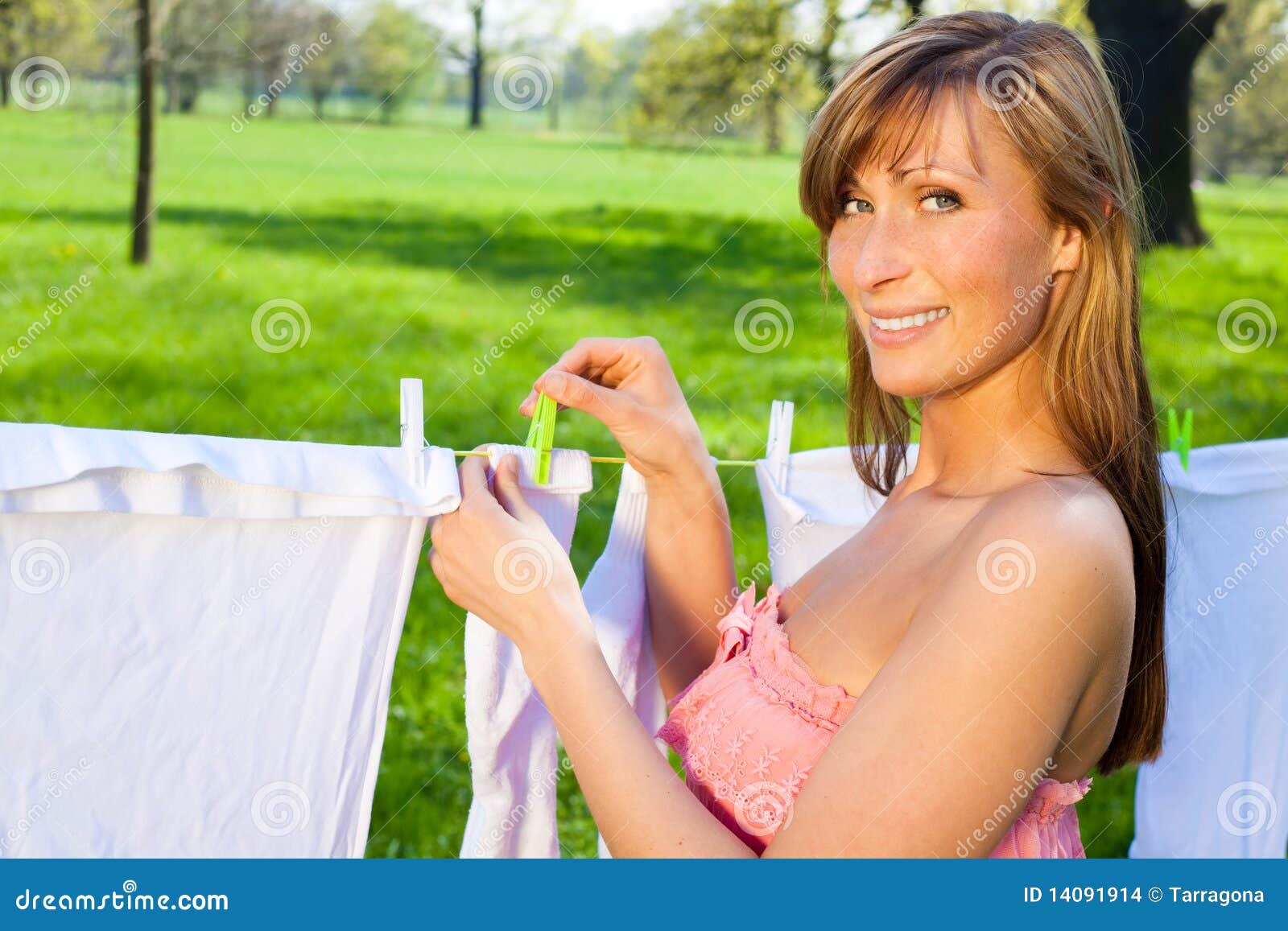 Female peg out washing stock photo. Image of green, housework 14091914