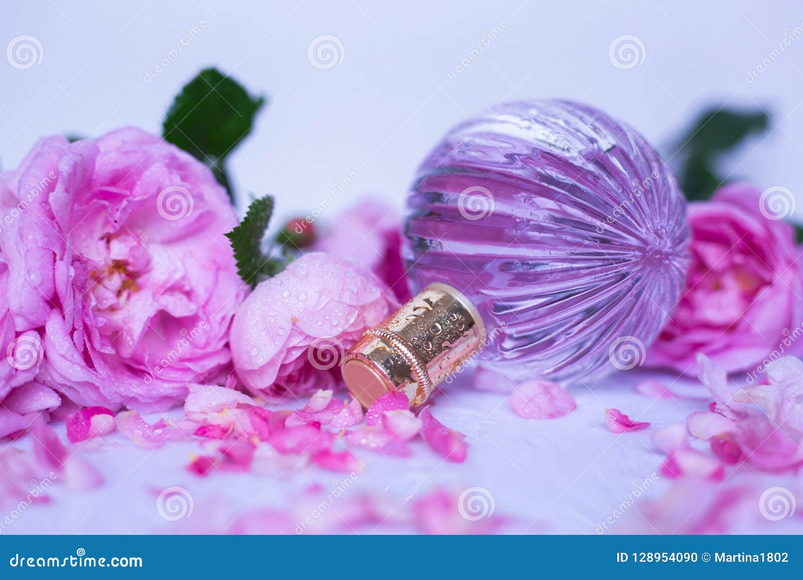 Pink Perfume Bottle with Flowers on Light Background Stock Photo ...