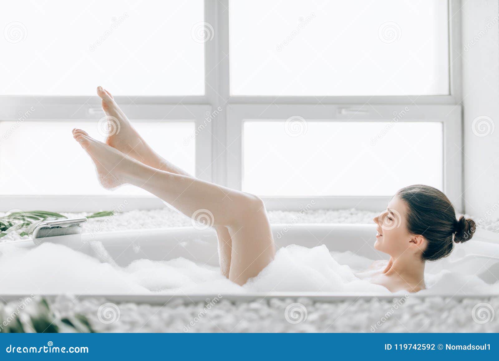 Attractive lady lying in bath with rose petals Stock Photo by NomadSoul1