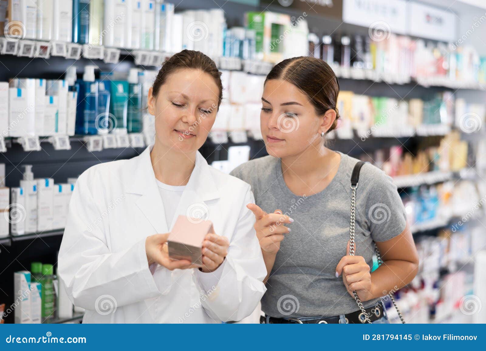 Female Pharmacist Advises a Woman Visitor a Good Skin Care Remedy ...