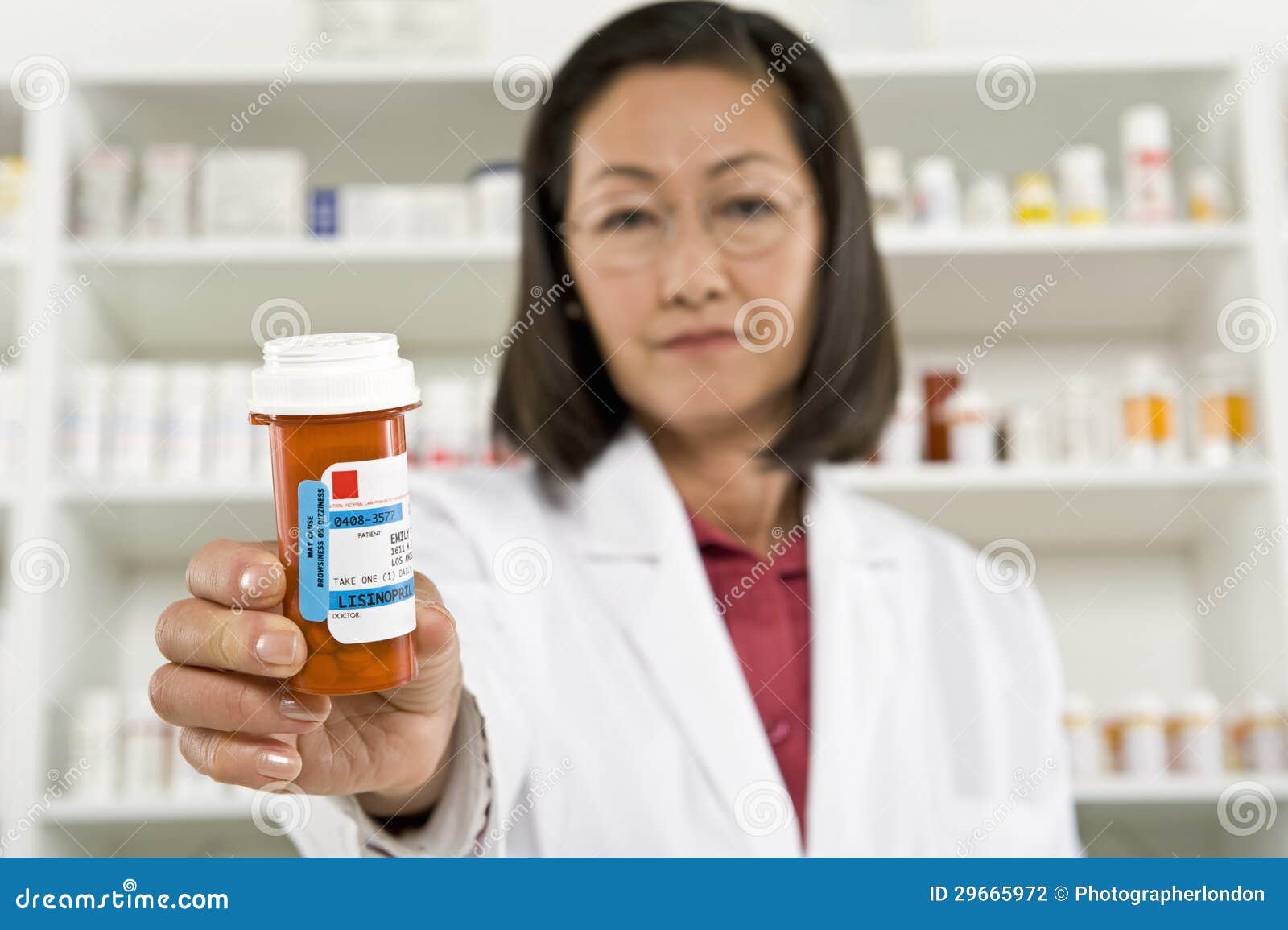 female pharmacist holding prescription drugs