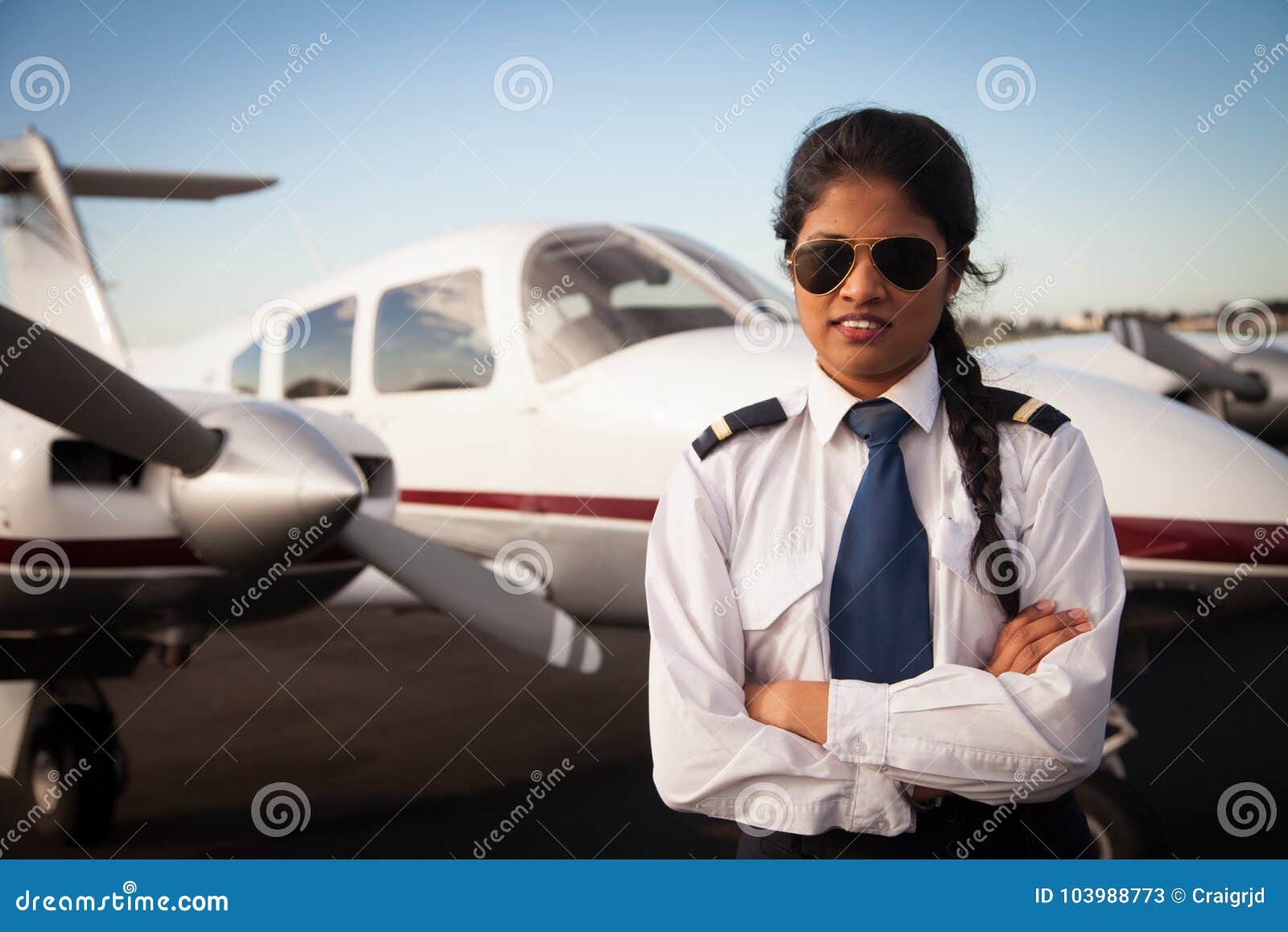 female pilot waiting in front of her aircraft