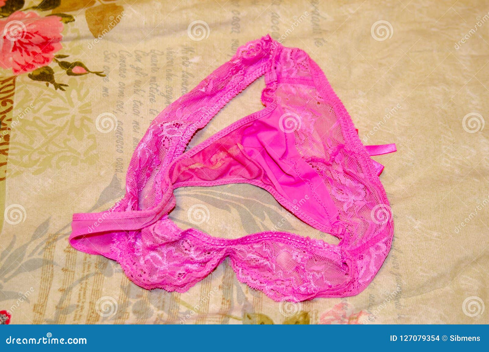 Female, Pink, Used Panties String on the Bed. Fetish. Stock Photo