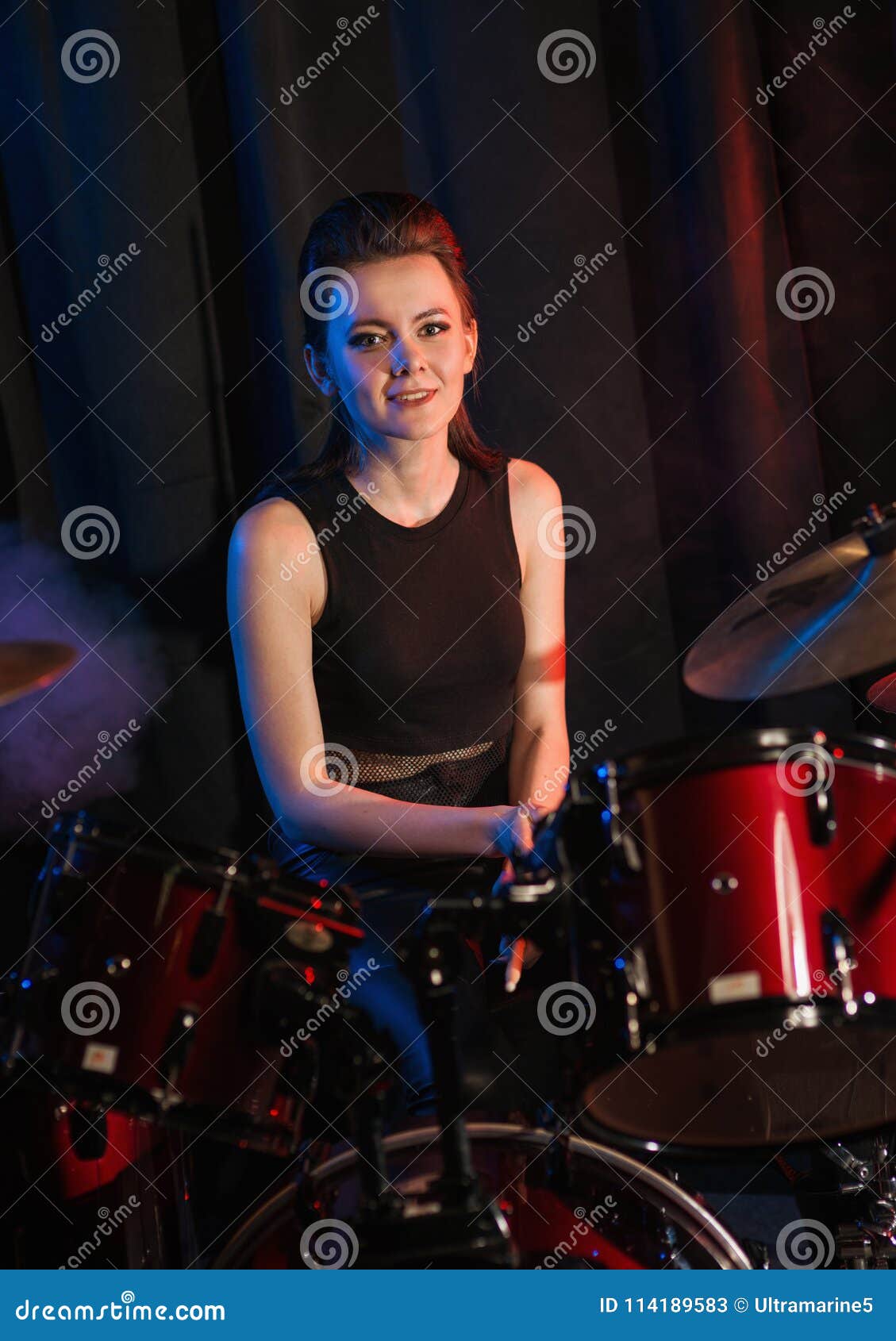 Female playing on drumset stock image. Image of musician 114189583