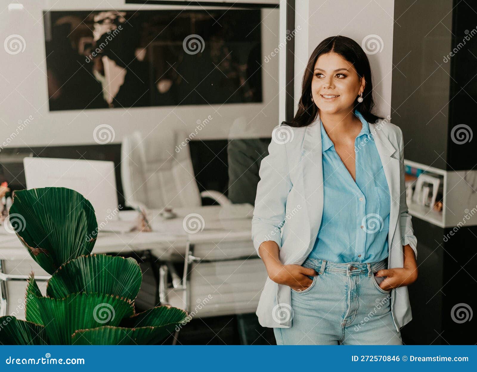 Female Professional at Her Home Office, Smiling with Contentment Stock