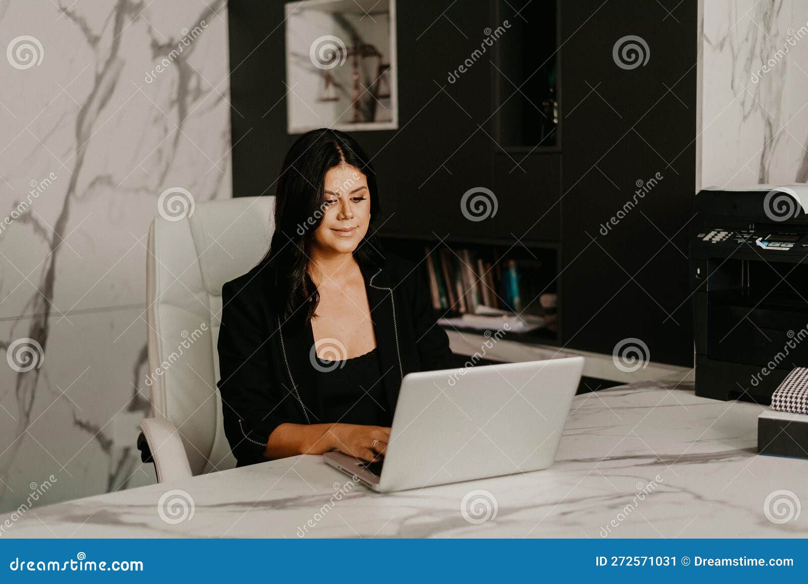 Female Professional at Her Home Office, Smiling with Contentment Stock