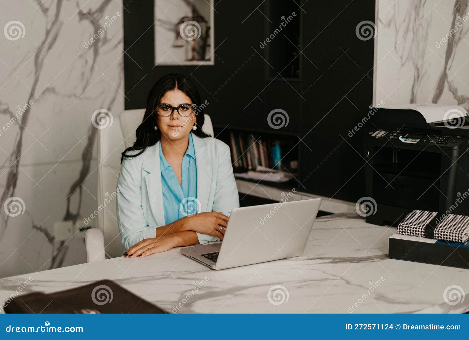 Female Professional at Her Home Office, Smiling with Contentment Stock