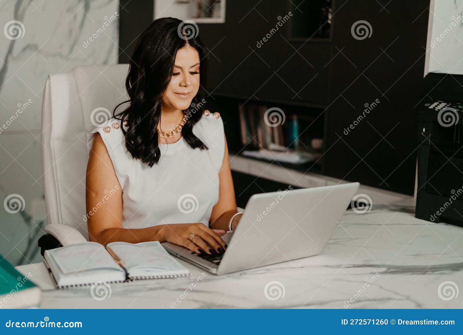 Female Professional at Her Home Office, Smiling with Contentment Stock