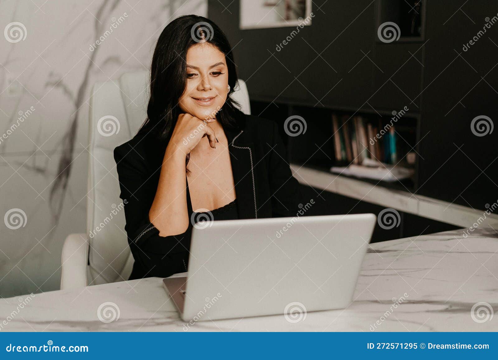 Female Professional at Her Home Office, Smiling with Contentment Stock