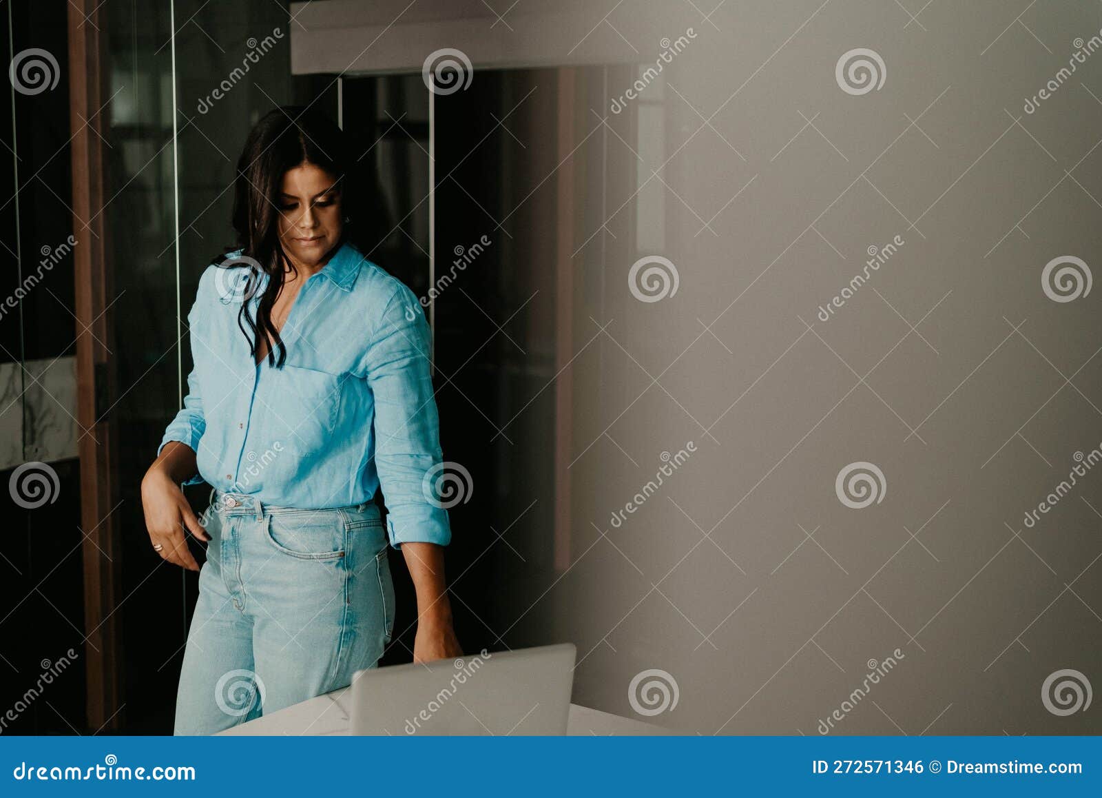 Female Professional at Her Home Office, Smiling with Contentment Stock