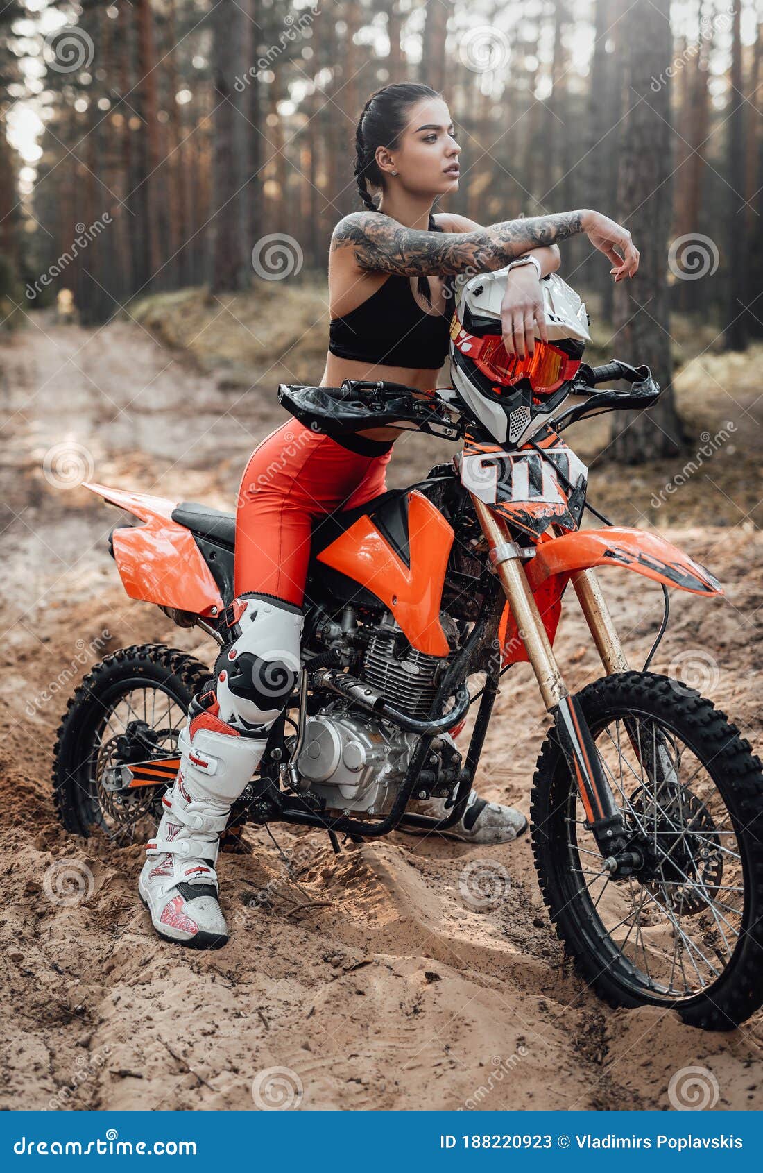 Female Racer Wearing Motocross Outfit with Semi Naked Torso Sitting on