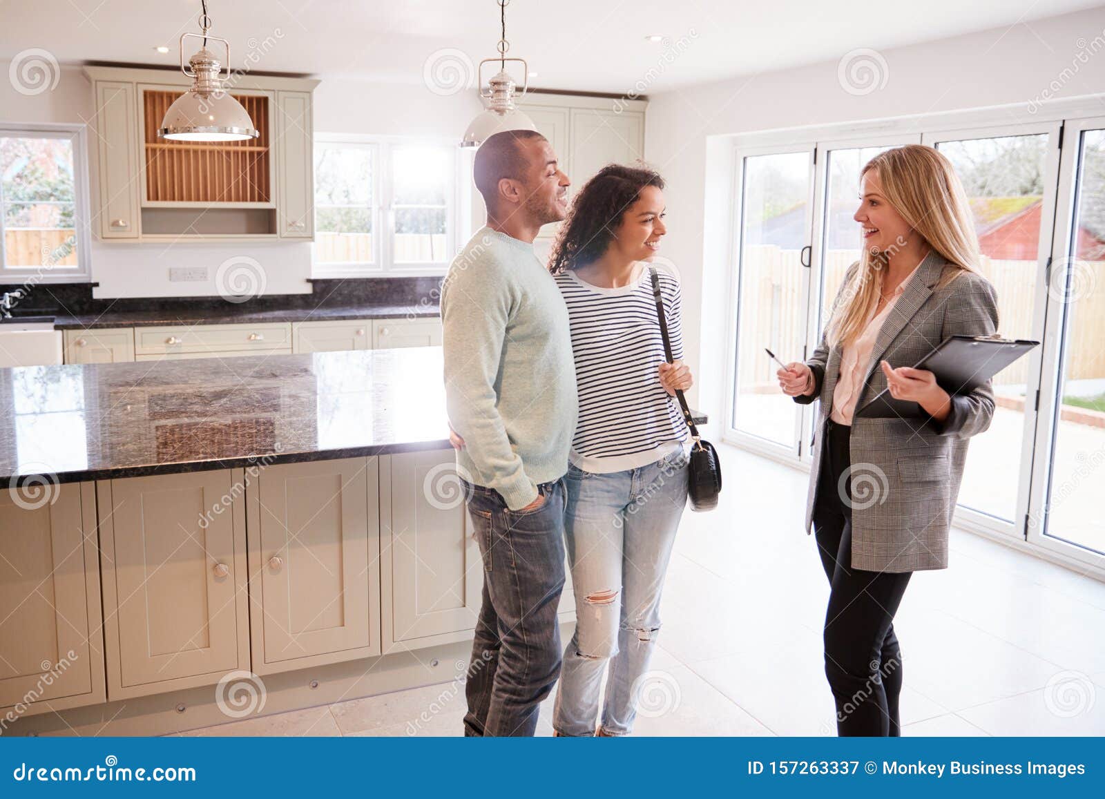 Female Realtor Showing Couple Interested In Buying Around House Stock Image Image Of Person 